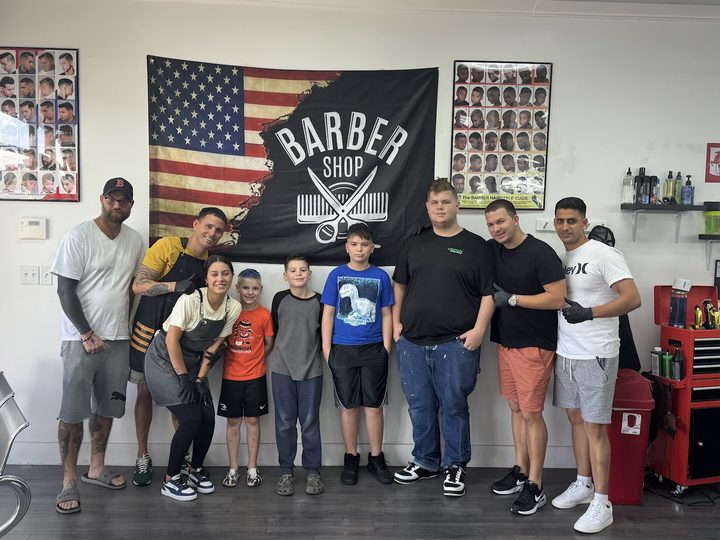 The Yovany Barber Shop crew and young clients at North Fort Myers